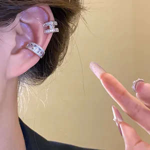Close-up view of elegant 18k gold plated zircon ear cuffs worn on the ear bone