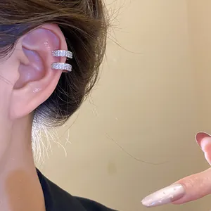 Close-up of triple-layered 18k gold plated ear cuff with sparkling pavé zircons