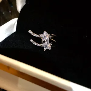 Detail shot of a sparkling star-shaped zircon ear cuff with elegant silver plating