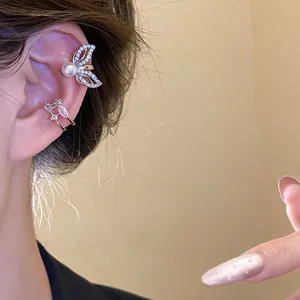 Close-up of elegant 18k gold plated ear cuffs with butterfly and marquise zircon