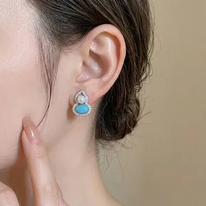 Elegant silver gourd-shaped stud earrings with blue stone pearl and cubic zirconia accents