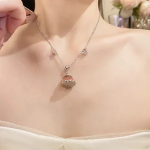 Close-up of elegant zircon resin pudding pendant necklace on female model neck