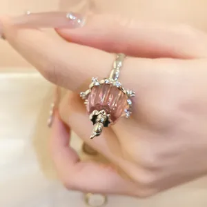 Macro view of a delicate pink resin pudding ring pendant with sparkling zircon
