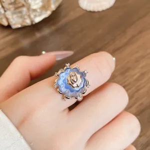 Macro detail shot of a unique blue resin pudding ring with sparkling zircon stone accents