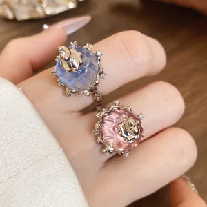 Close-up detail of elegant resin pudding rings with sparkling zircon accents on fingers