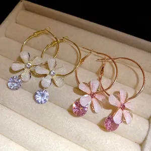 Elegant resin flower hoop earrings with sparkling zircon pendants in a jewelry box