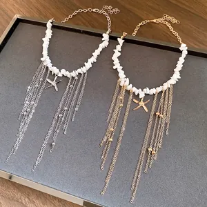 Bohemian starfish necklace with white stone beads and long metal tassels in gold