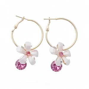 Elegant gold hoop earrings with white resin flower and sparkling pink zircon pendants