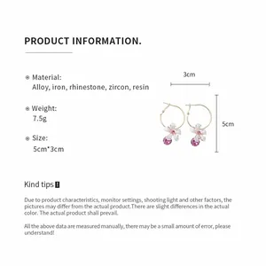 Detailed view of floral resin hoop earrings with size and material specifications