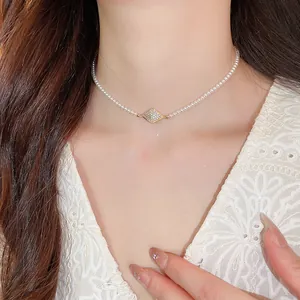 Close-up view of an elegant 18K gold plated zircon pearl choker necklace on a model