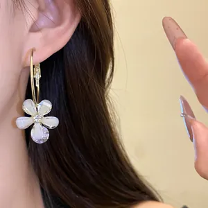 Detailed view of elegant resin flower hoop earrings with a sparkling zircon pendant
