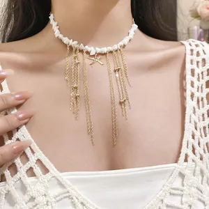 Detailed view of stone beaded necklace with golden starfish and tassels on model