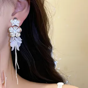 Vue détaillée des boucles d'oreilles fleurs en argent avec pétales et longs glands