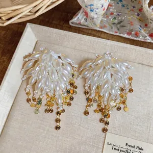 Elegant tassel earrings with lustrous faux pearls and gold-toned sequins for women