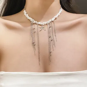 Close-up of bohemian starfish necklace with white stone beads and long silver chain tassels