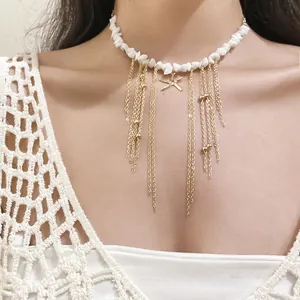 Close-up of white stone beaded necklace with gold starfish and chain tassels