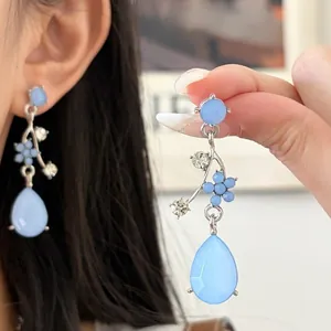 Detailed close-up of blue floral rhinestone teardrop earrings for women