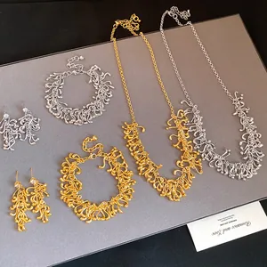 Elegant set of irregular metallic fringe necklaces and bracelets in gold and silver finishes