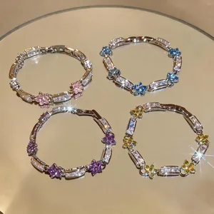 Elegant light luxury metal bracelets featuring colorful zirconia flowers and buckle clasps.