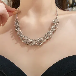 Detailed view of silver irregular fringe necklace on model for chic vintage look.