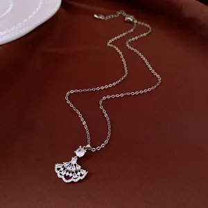 Detailed view of elegant silver fan-shaped pendant necklace with sparkling zircons.