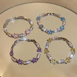 Detailed view of luxury flower bracelets with sparkling cubic zirconia in four colors