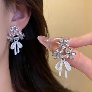 Elegant silver needle flower stud earrings with sparkling zircon and white enamel bow