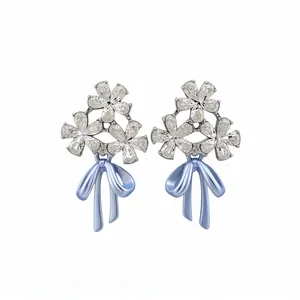 Elegant floral zircon stud earrings with light blue bowknot drops on white background
