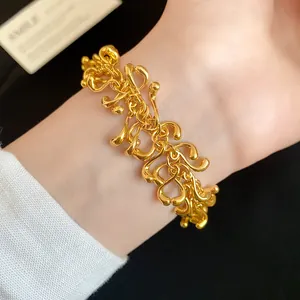 Detailed macro view of irregular chunky gold geometric link bracelet worn on a wrist