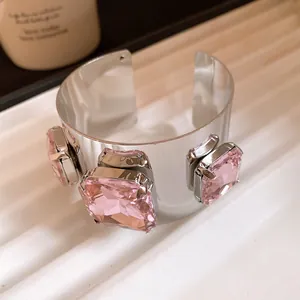 Detailed view of luxury silver cuff bracelet featuring large square pink gemstones