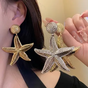 Vintage oversized starfish drop earrings with metallic wrinkled texture in gold and silver