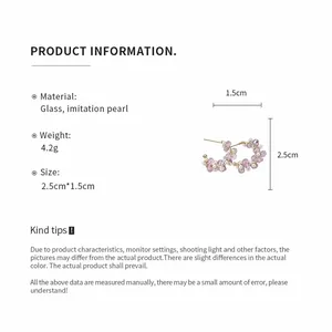 Detail of beaded C-shaped stud earrings featuring purple glass and imitation pearls