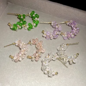 Detailed view of handmade beaded C-shaped hoop earrings with colorful glass pearls