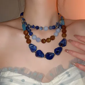 Vue détaillée du collier ethnique multicouche en résine acrylique avec perles bleues et ambre
