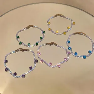 Minimalist zircon bracelet set with colorful round gemstones in silver finish.