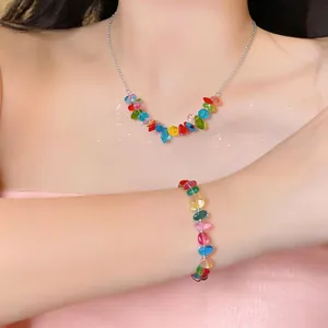 Colorful beaded stainless steel necklace and bracelet jewelry set worn by a female model