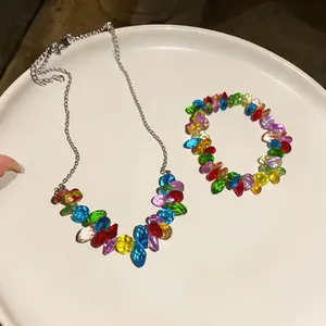 Close-up detail of a colorful beaded necklace and bracelet set displayed on a white tray