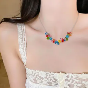 Close-up view of a vibrant colorful beaded stainless steel necklace on a model's neck