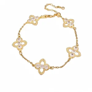 Elegant gold-tone lucky clover flower bracelet with sparkling white zircons and hollow motifs