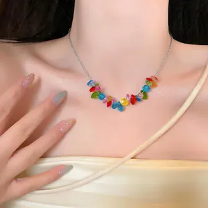 Close-up detail of a colorful beaded stainless steel necklace worn by a female model