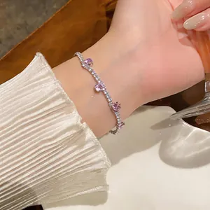 Close-up detail of an elegant silver-tone bracelet featuring pink and clear zircons