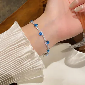 Detailed view of an elegant silver-tone bracelet featuring vibrant blue and white zircons