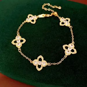 Elegant gold bracelet featuring five hollow clover motifs inlaid with sparkling zircons