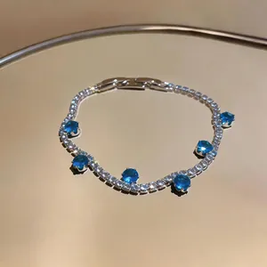 Detail view of a luxury zircon bracelet featuring round blue stones and sparkling accents