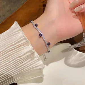 Close-up of elegant silver bracelet with purple zircon stones on a wrist