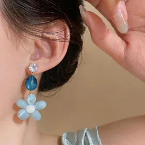 Elegant blue resin flower stud earrings with zircon detail and silver needle pins