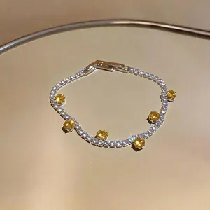 Elegant silver-toned bracelet with clear and yellow round faceted cubic zirconia