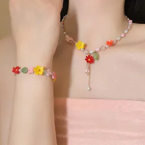 Elegant resin flower necklace and matching beaded bracelet set worn by a female model