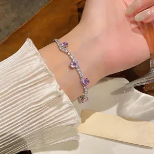 Detailed view of an elegant silver zirconia bracelet with pink stones worn on a wrist