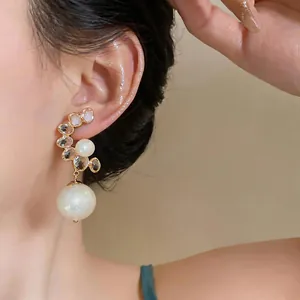 Detailed view of luxury French vintage earrings featuring white pearls and faceted crystals
